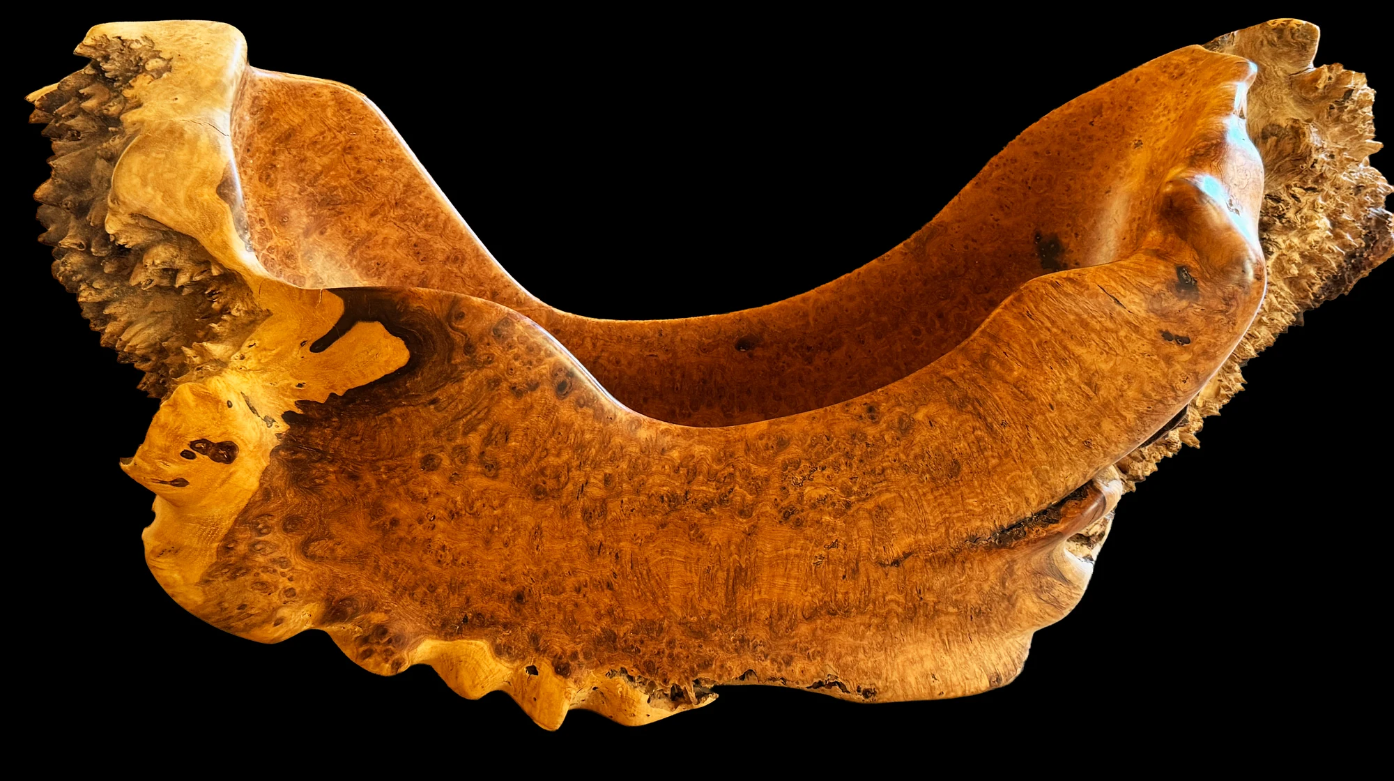 Smiles for Miles — a large hand-carved Amboyna Burl vessel with an undulating rim, photographed against black
